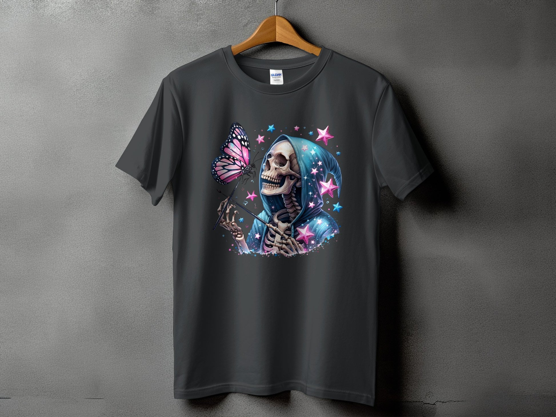 Skeleton with butterfly and stars graphic on a dark grey t-shirt.