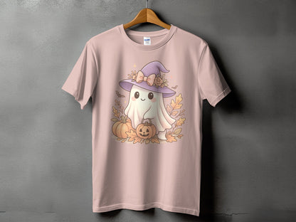 Pink t-shirt with a smiling ghost wearing a witch hat, holding a pumpkin basket, surrounded by pumpkins and leaves.