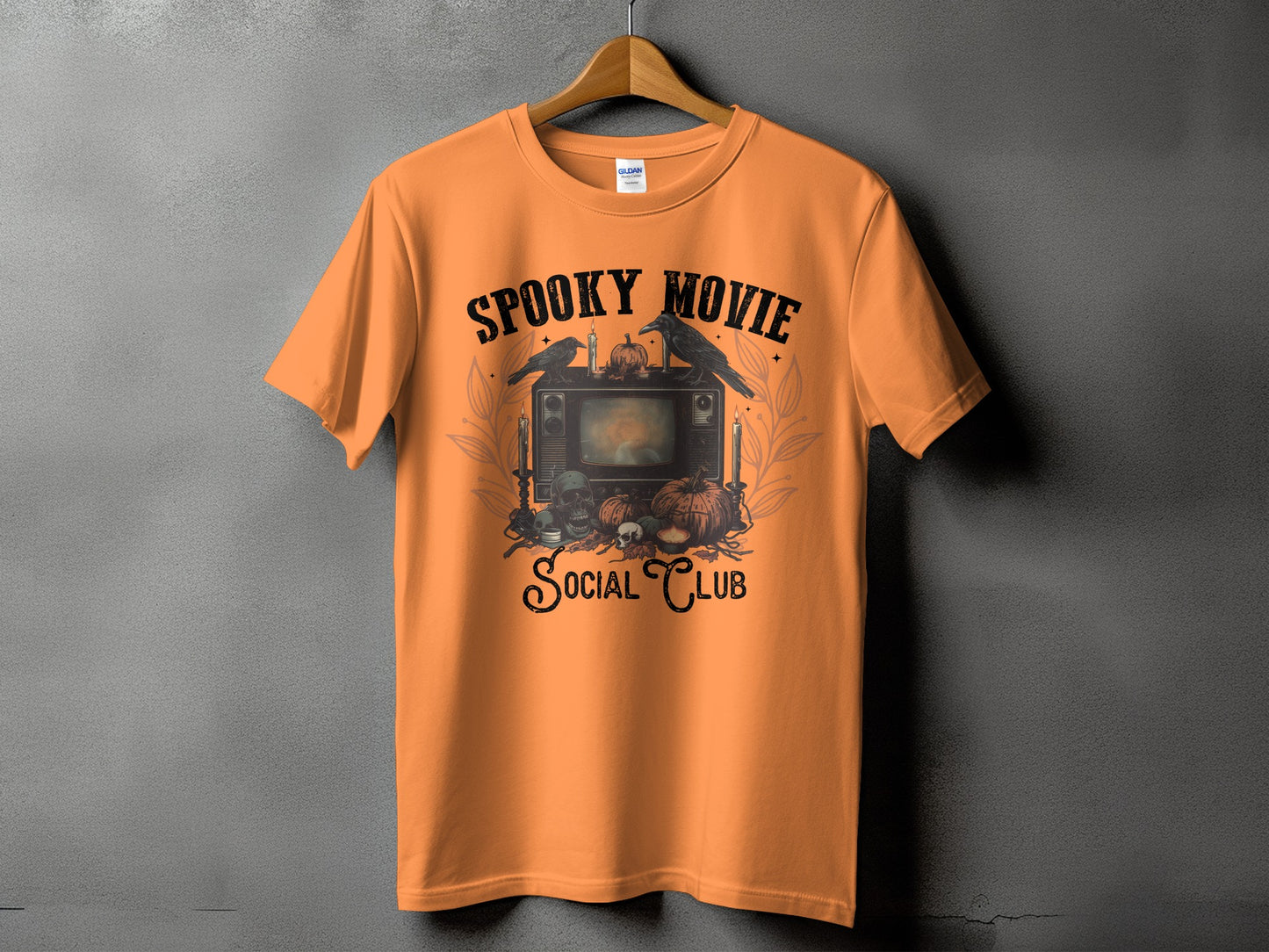 Orange t-shirt with spooky Halloween graphic and text "Spooky Movie Social Club".