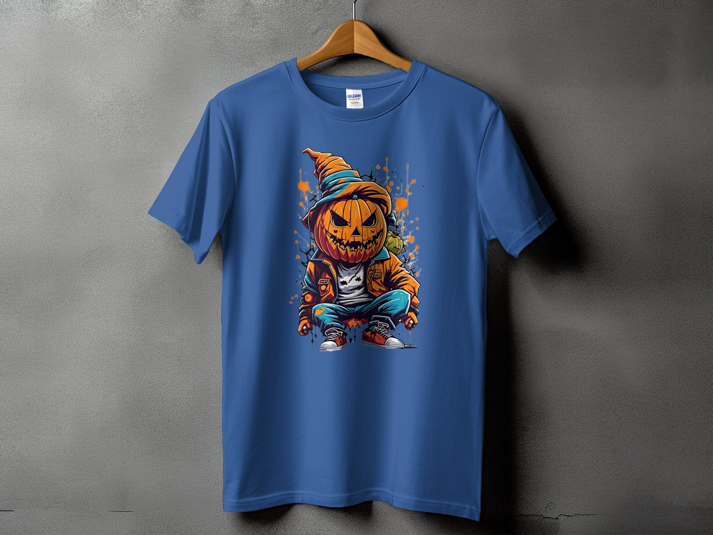 Blue t-shirt with a cartoon pumpkin character in a hat and jacket.