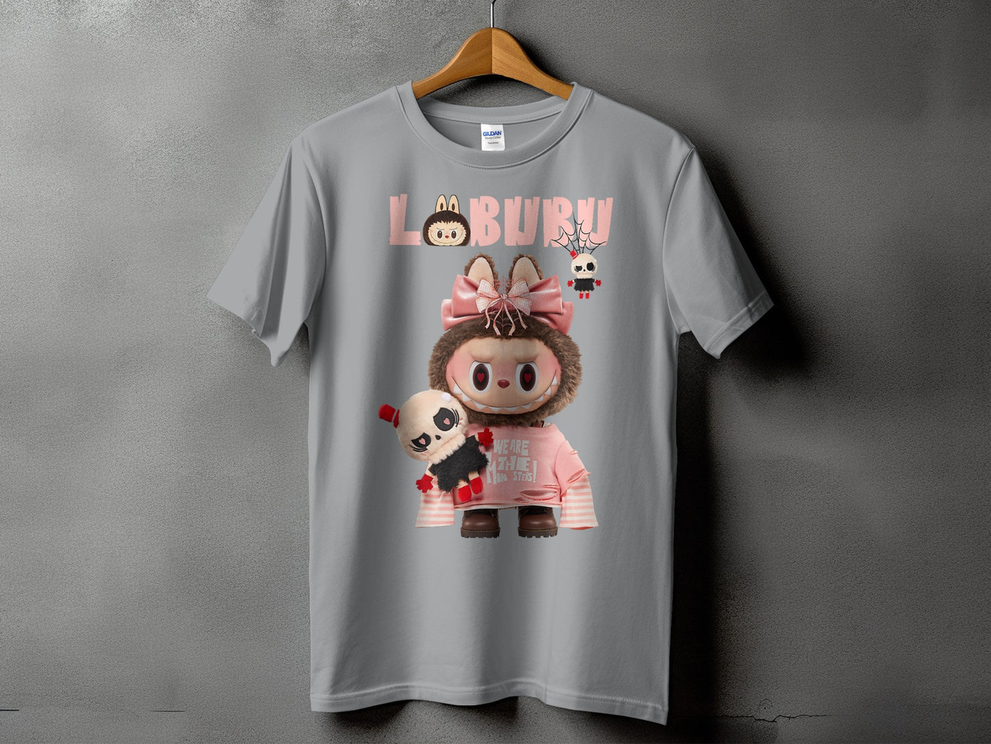 Gray t-shirt with pink "LABURM" text and a character holding a doll.