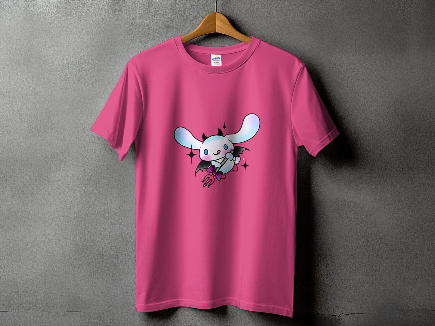 Pink t-shirt with a cartoon white dog character in devil costume graphic.