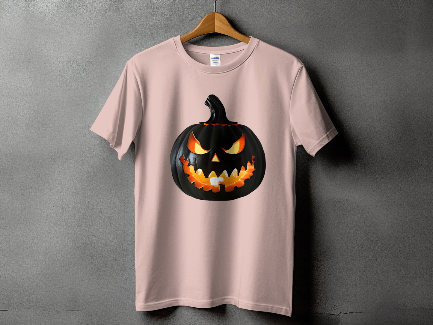 Pink t-shirt with a black, glowing jack-o'-lantern graphic.