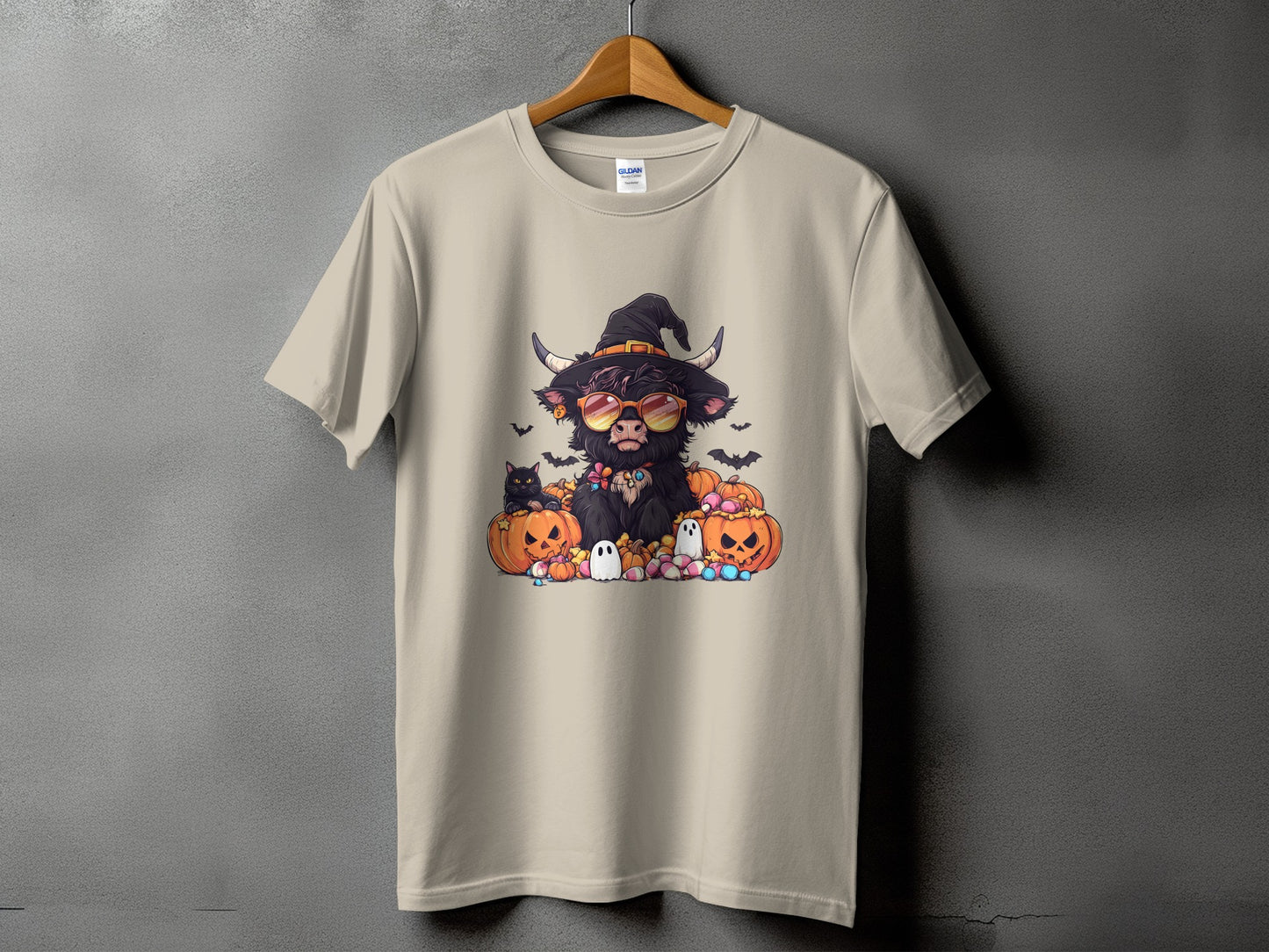 Highland cow in witch hat and sunglasses surrounded by pumpkins and ghosts.