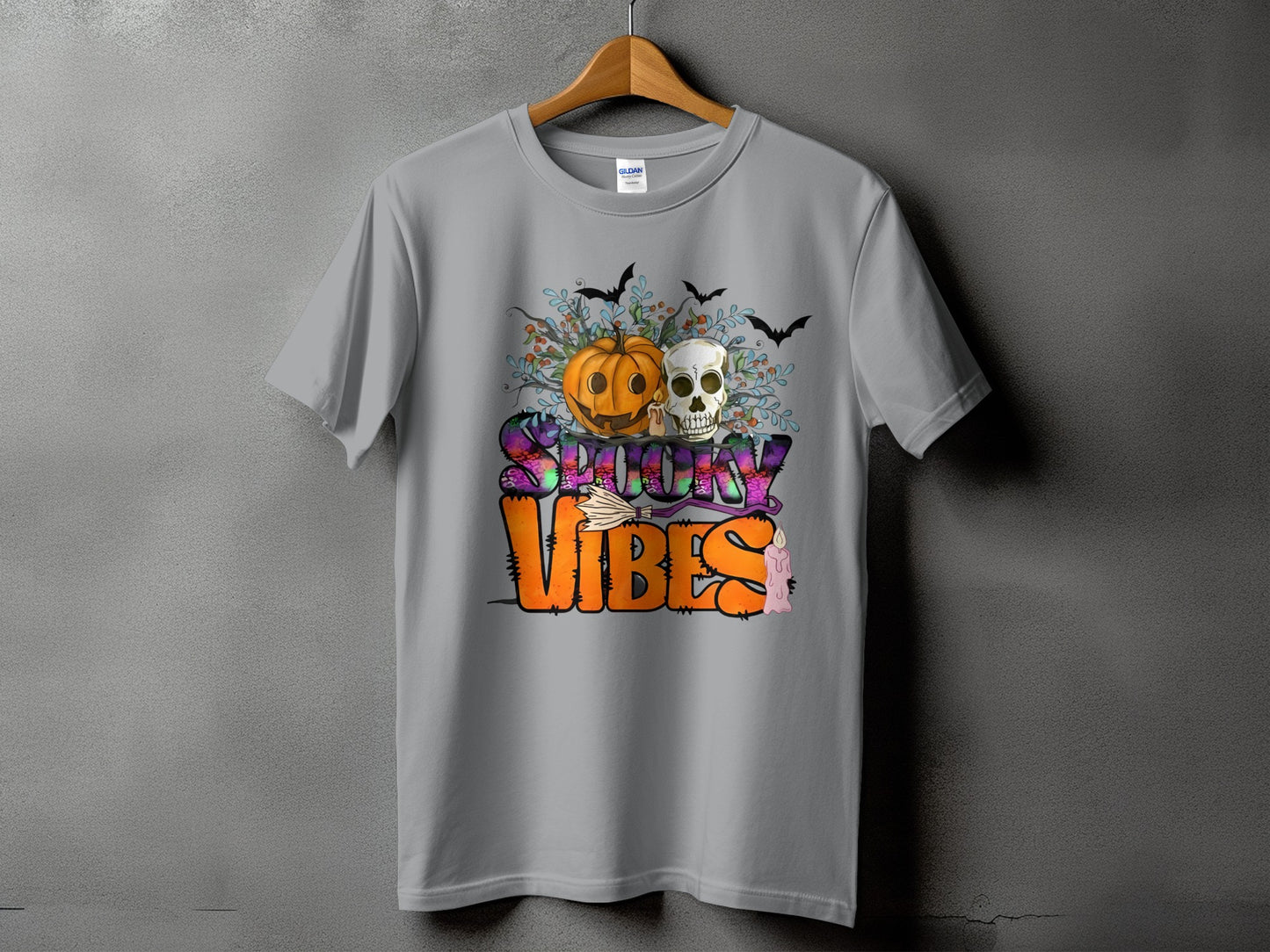 Gray t-shirt with "Spooky Vibes" graphic featuring a pumpkin, skull, bats, and candle.