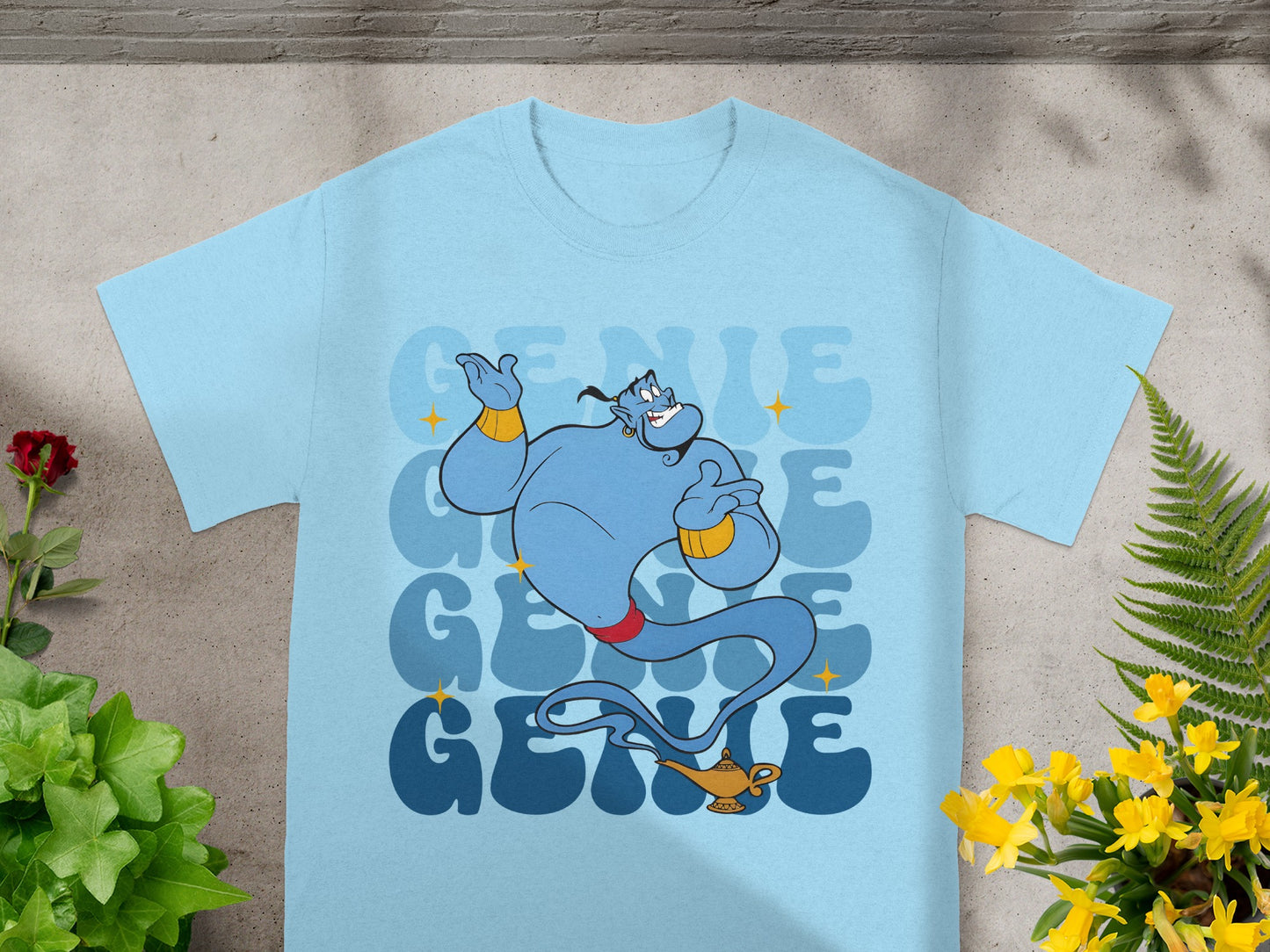 Light blue t-shirt with a cartoon genie from Aladdin and repeating "Genie" text.