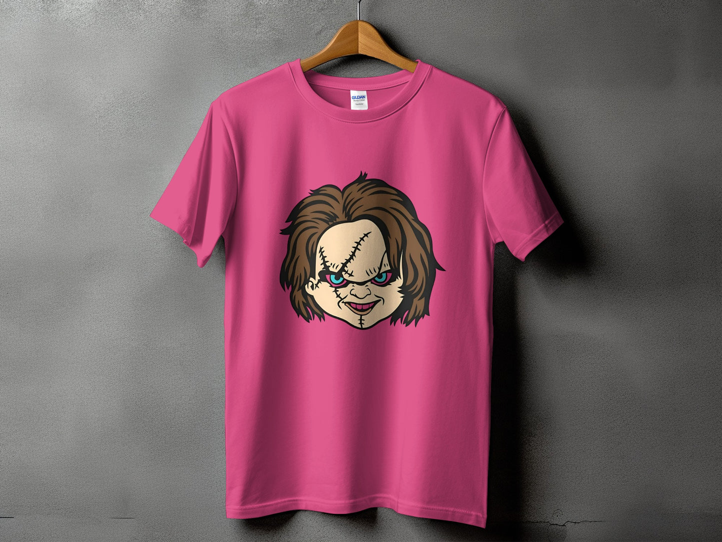 Pink t-shirt with Chucky's cartoon face graphic.