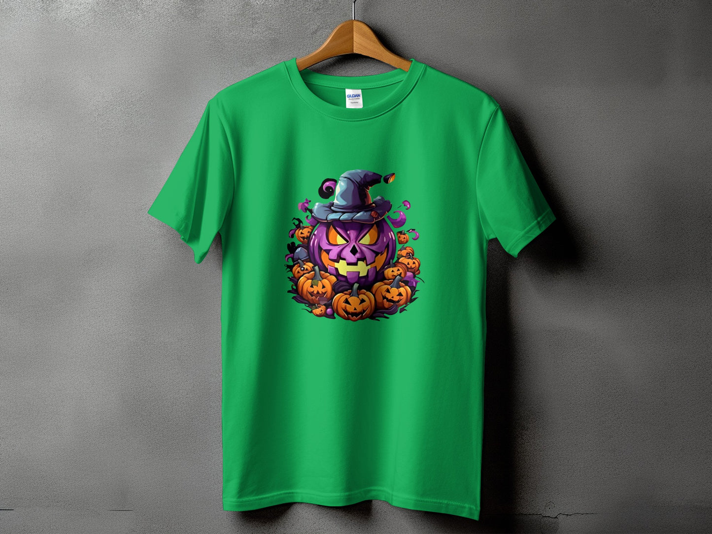 Green t-shirt featuring a cartoon Halloween pumpkin with a witch hat and surrounding pumpkins.