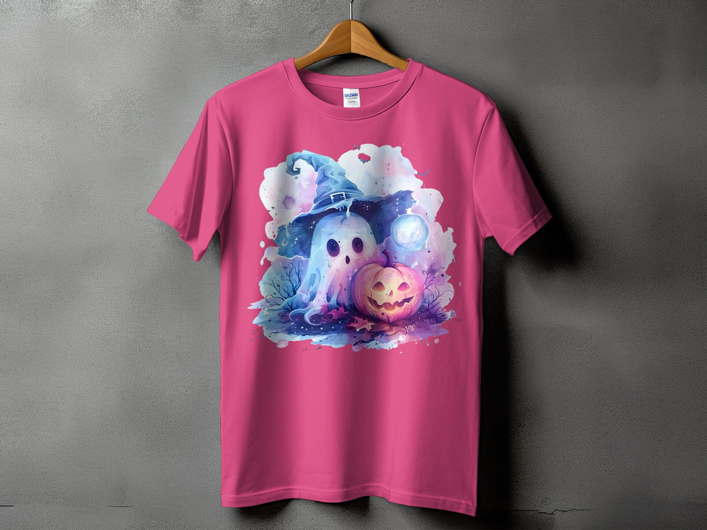 Pink t-shirt featuring a cartoon ghost in a witch hat and a jack-o'-lantern.