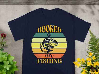Navy t-shirt with "Hooked on Fishing" text and fish graphic on circle.