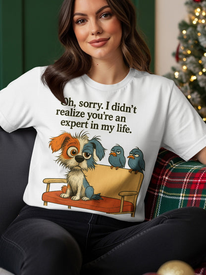 T-shirt with a cartoon dog and birds sitting on a couch, reading "Oh, sorry. I didn't realize you're an expert in my life."