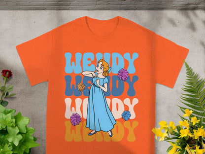 Orange t-shirt with Wendy text and cartoon of girl dancing.