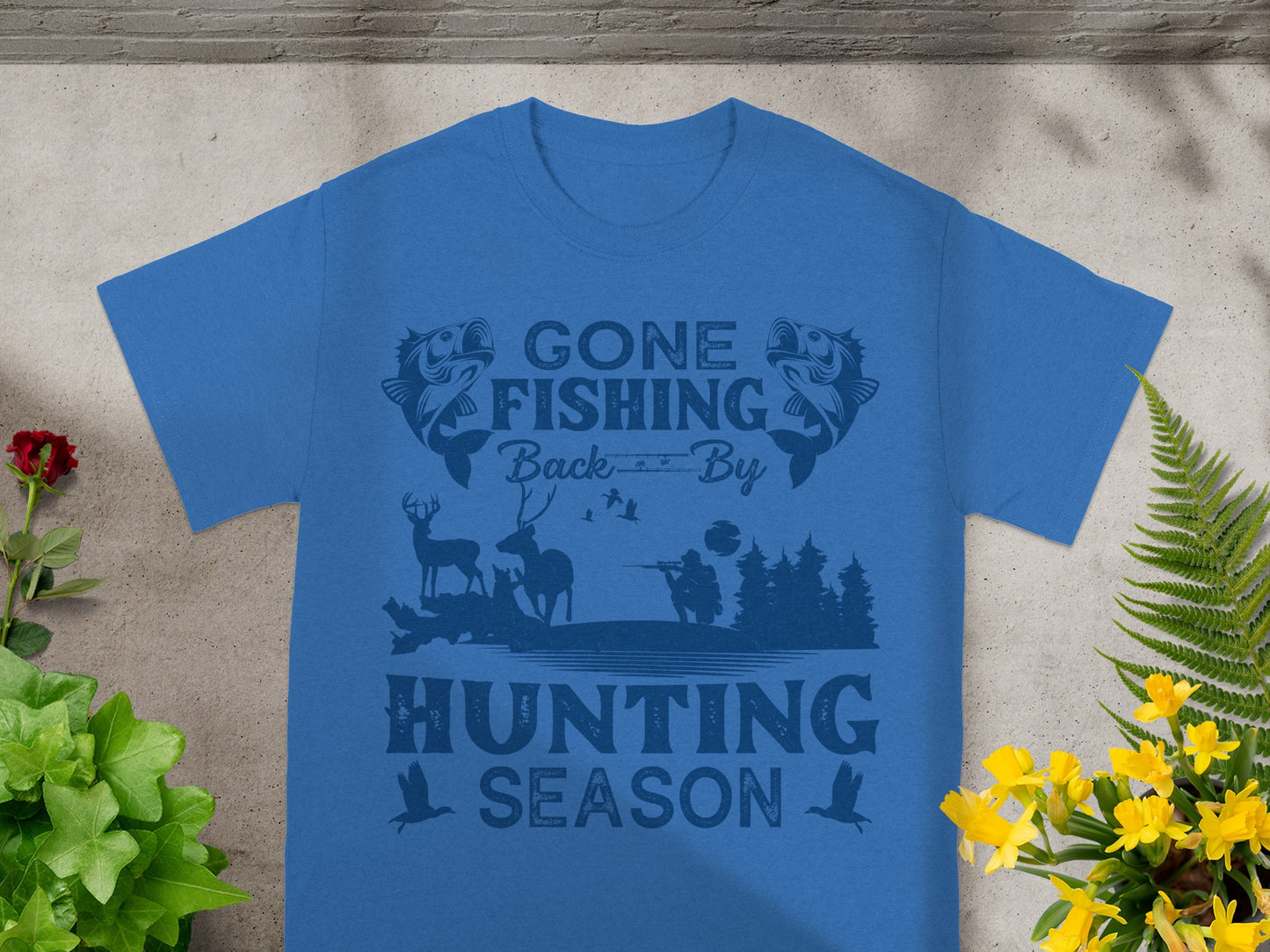 Blue t-shirt with "Gone Fishing Back By Hunting Season" text and fishing/hunting graphics.