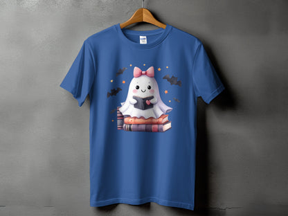 Blue t-shirt with a cartoon ghost reading a book surrounded by bats and stars.