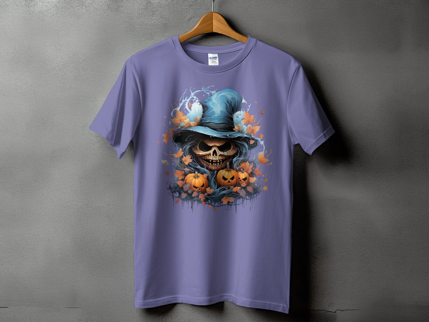 Purple t-shirt with a spooky skull wearing a witch hat, pumpkins, and autumn leaves.