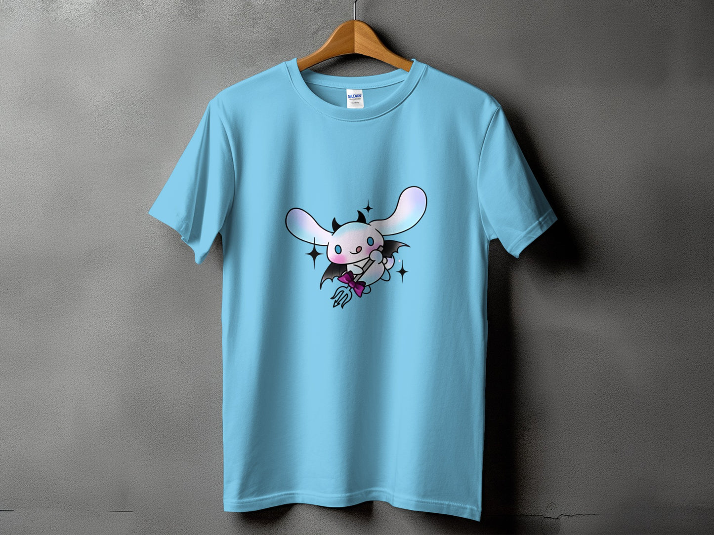 Light blue t-shirt with a cartoon devilish bunny holding a pitchfork.