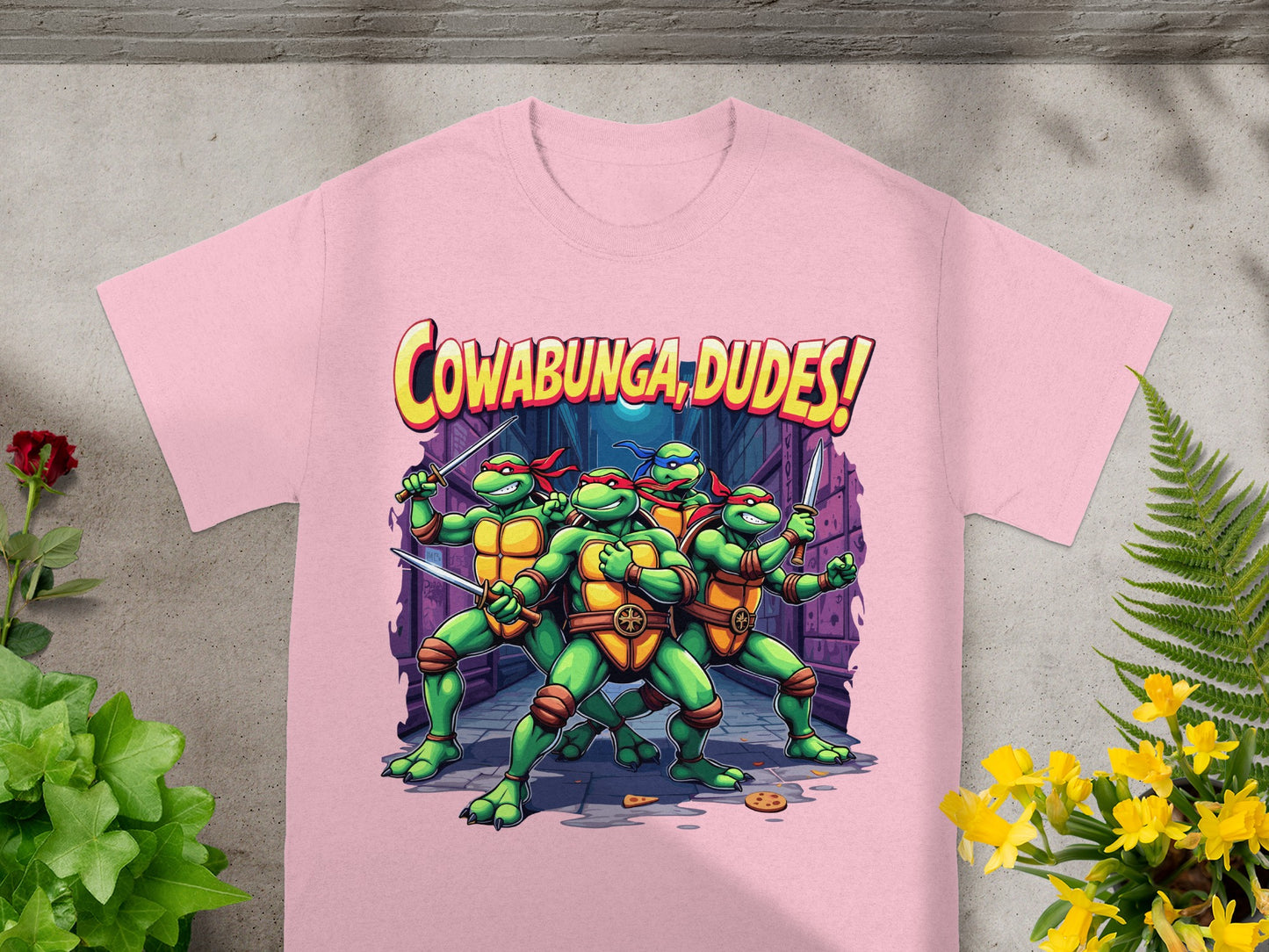 Teenage Mutant Ninja Turtles with swords and "Cowabunga, Dudes!" text on pink t-shirt.