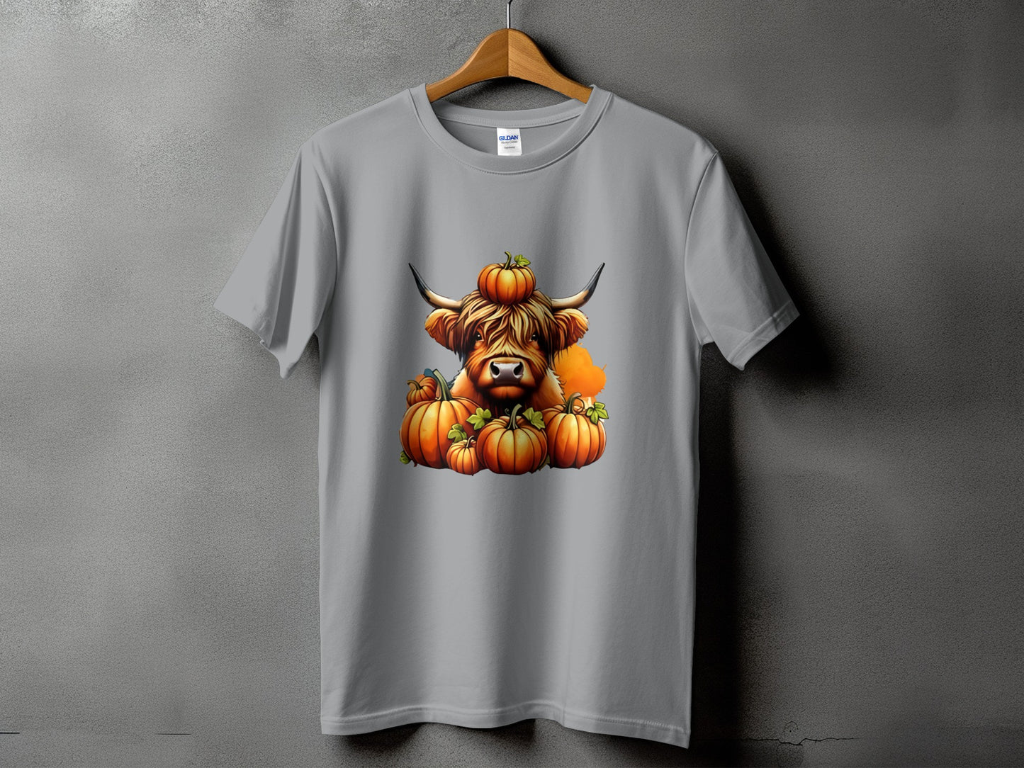 Grey t-shirt featuring a Highland cow surrounded by pumpkins.