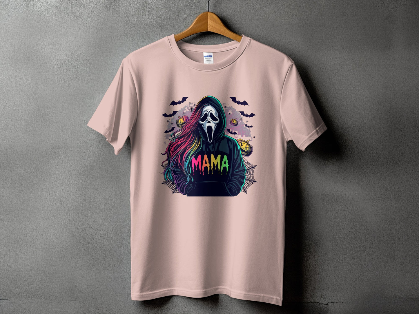 Pink t-shirt with a Halloween graphic featuring a ghost face and "Mama" text.