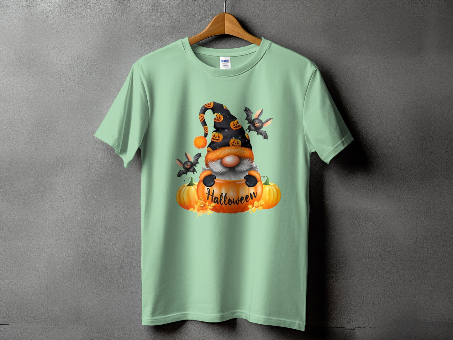 Light green t-shirt with Halloween gnome, pumpkins, and bats graphic.