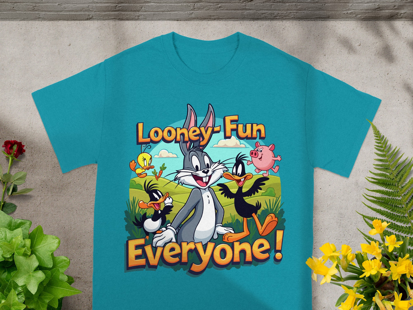 Looney Tunes characters Bugs Bunny, Daffy Duck, Tweety, and Porky Pig on a teal t-shirt.