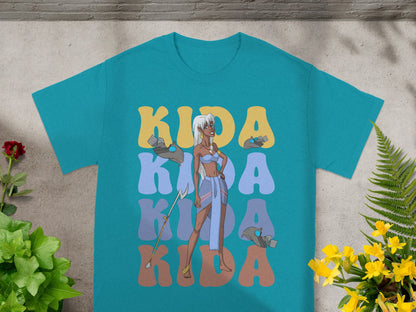 Kida standing in front of "KIDA" text on a teal t-shirt.