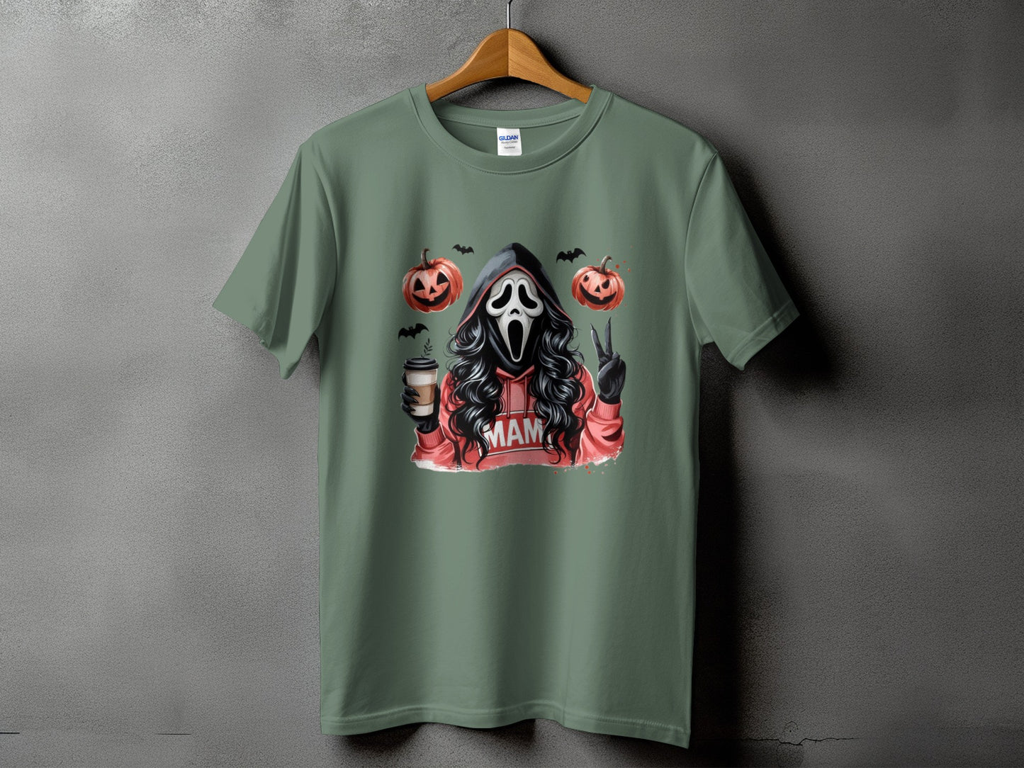 Green t-shirt with a ghost mask, pumpkins, bats, coffee, and "MAM" text.