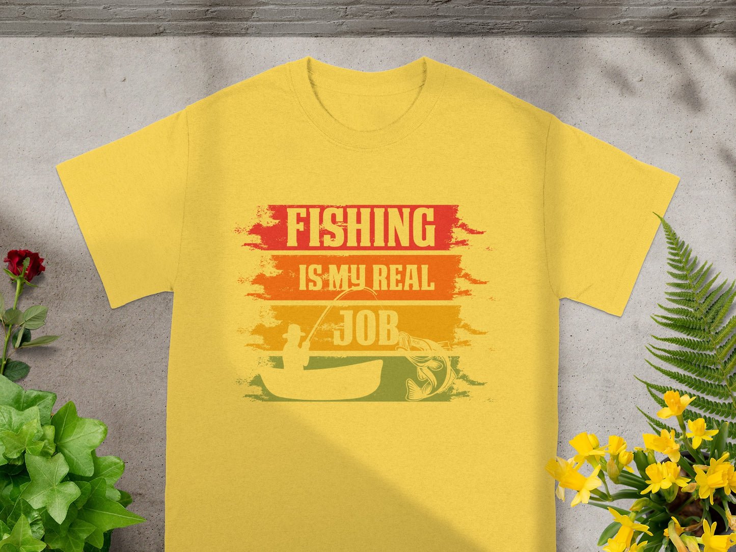 Yellow t-shirt with "FISHING IS MY REAL JOB" text and fishing graphic.