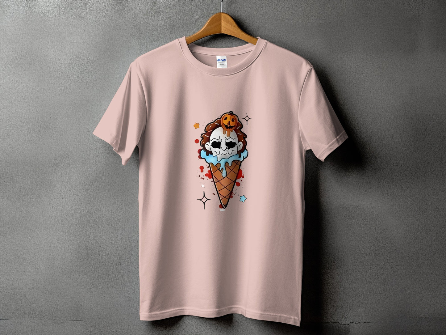 Pink t-shirt with a Halloween ice cream cone graphic featuring a skull and pumpkin.