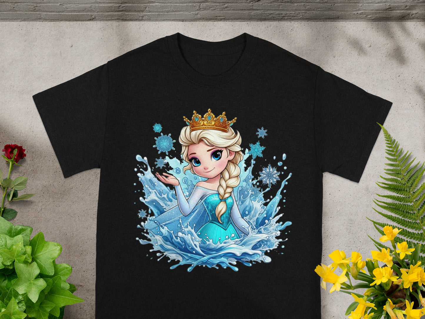 Black t-shirt featuring Elsa from Frozen in a sparkly blue dress surrounded by water and snowflakes.