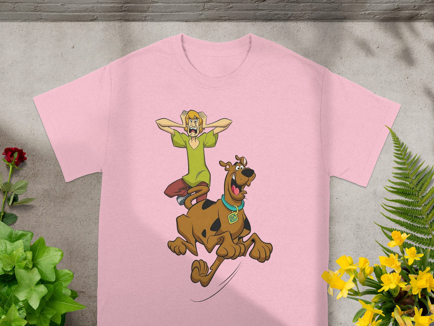 Pink t-shirt with cartoon Shaggy and Scooby-Doo running.