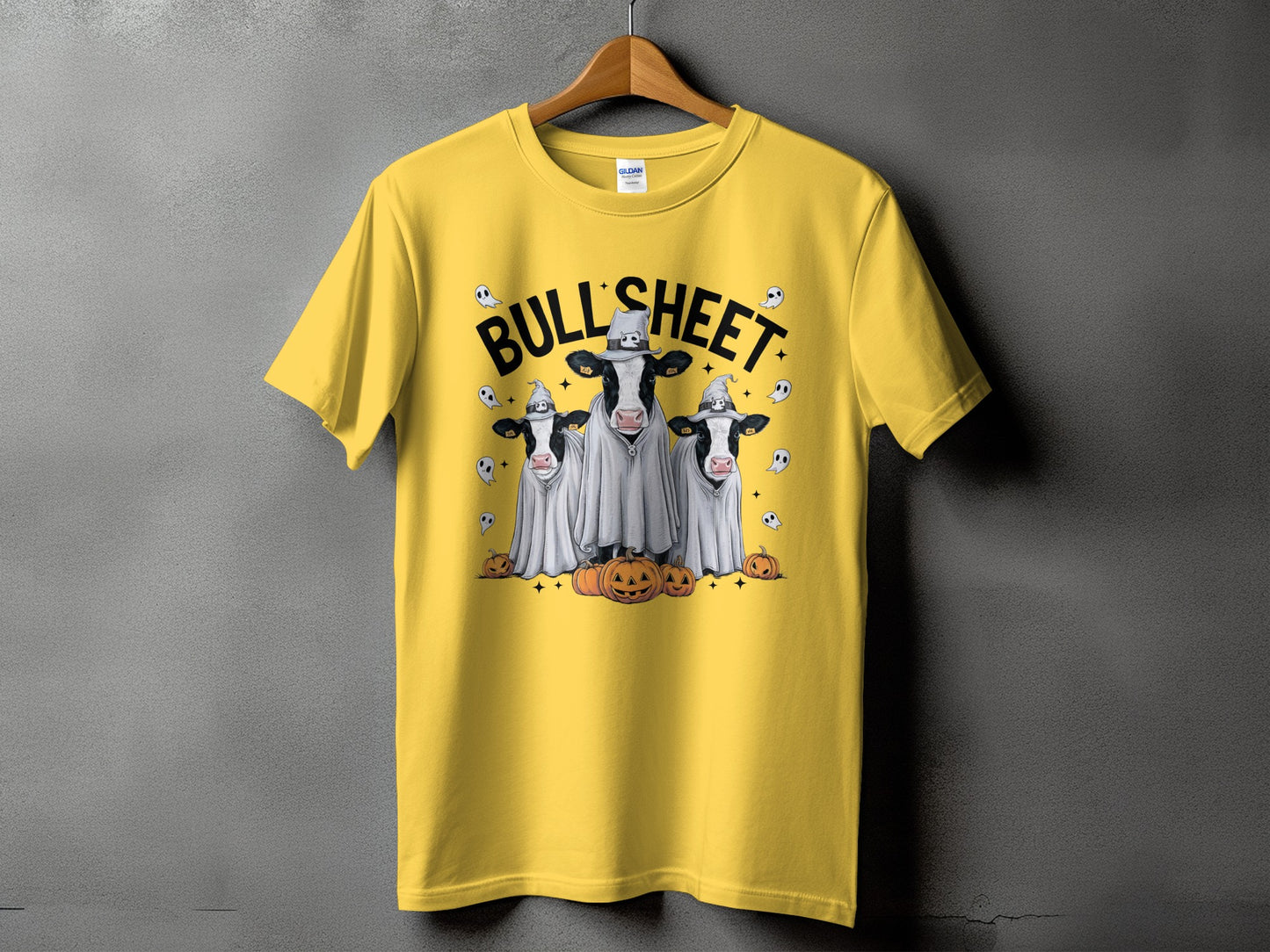 Yellow t-shirt with "BULLSHEET" text and three cows dressed as ghosts with pumpkins.
