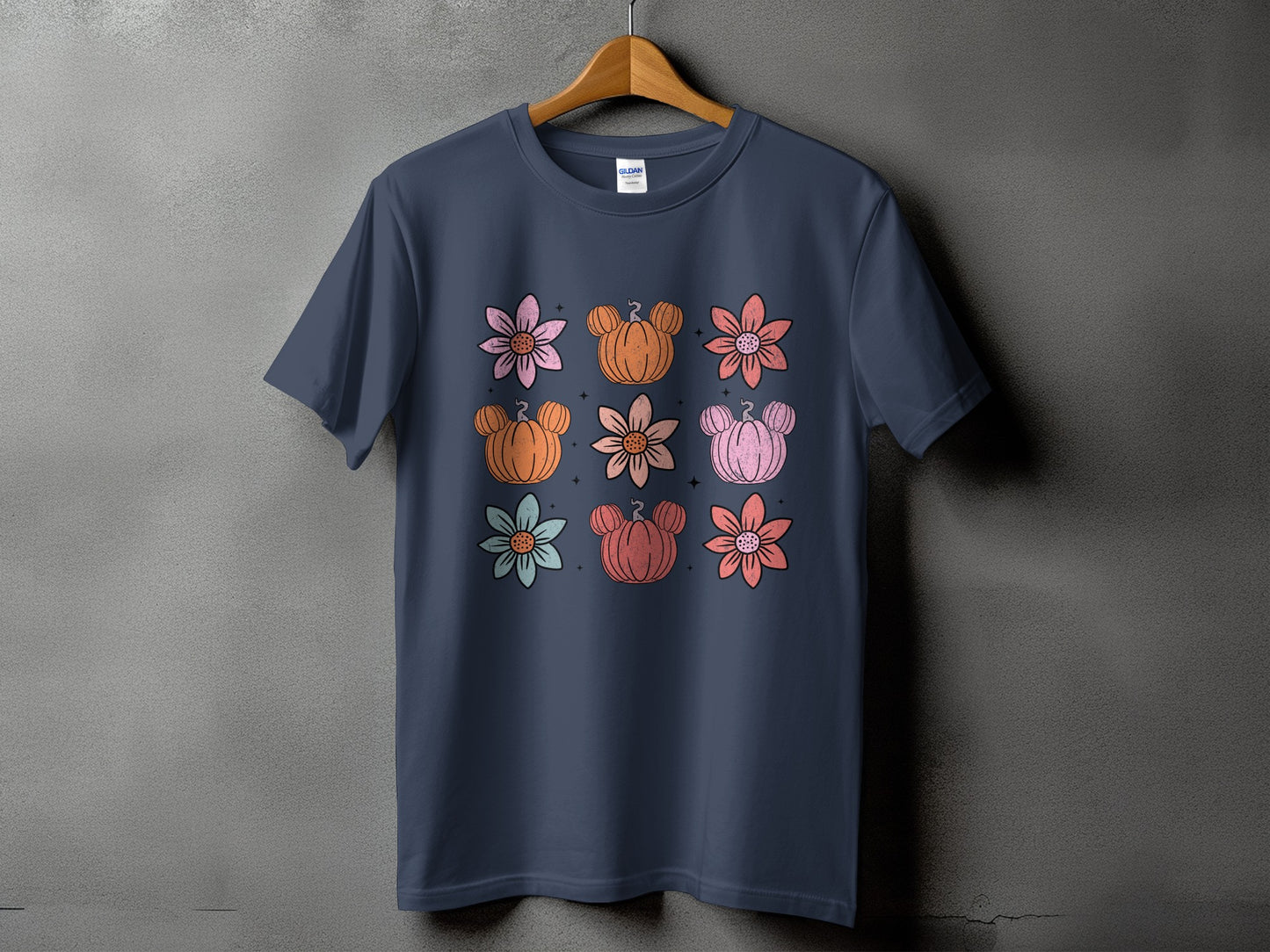 Dark blue t-shirt with a grid of stylized flowers and pumpkins.