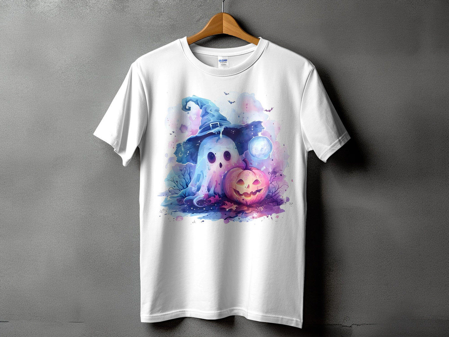 White t-shirt with ghost wearing witch hat and jack-o'-lantern graphic.