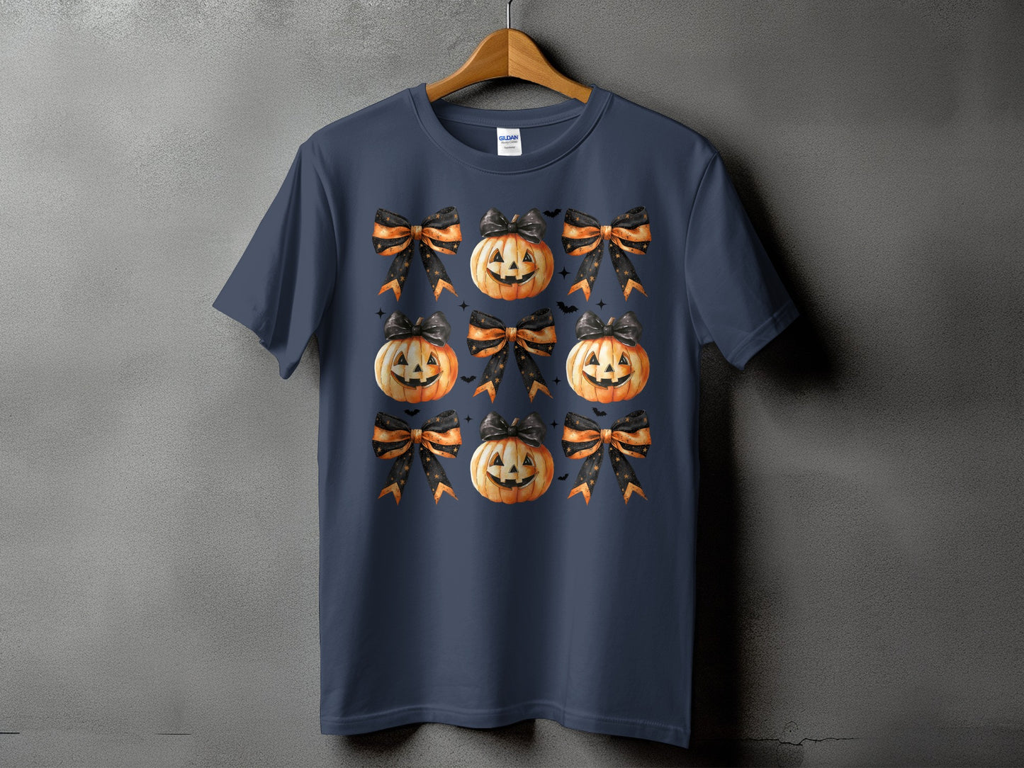 Dark blue t-shirt with a repeating pattern of jack-o'-lanterns and bows.