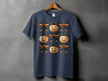 Dark blue t-shirt with a repeating pattern of jack-o'-lanterns and bows.