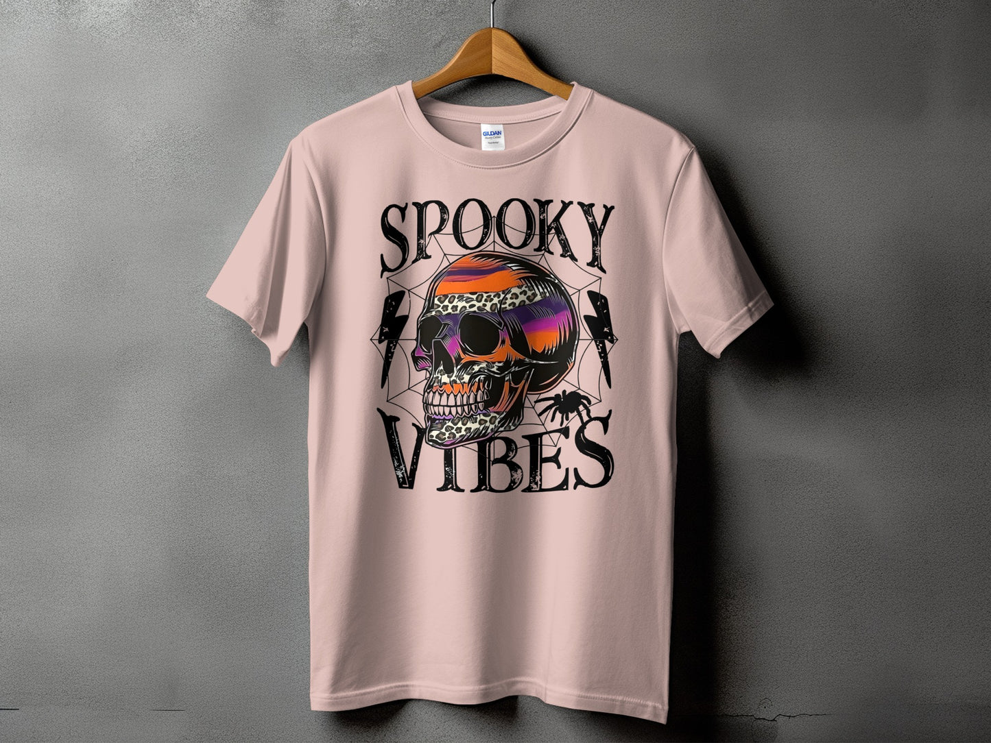 Pink t-shirt with spooky skull graphic and text "SPOOKY VIBES".