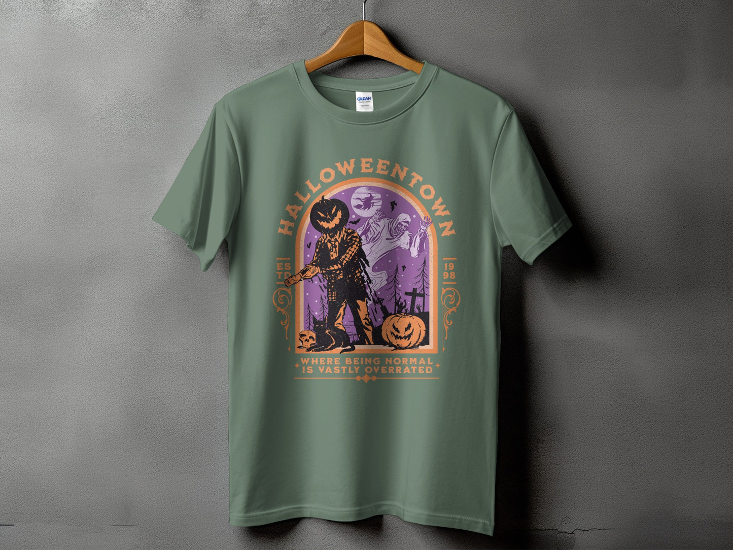 Green t-shirt with "Halloweentown" graphic featuring scarecrow, ghosts, pumpkin, and cat.