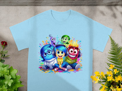 Inside Out characters Joy, Sadness, Fear, Anger, and Disgust smiling on a light blue t-shirt.