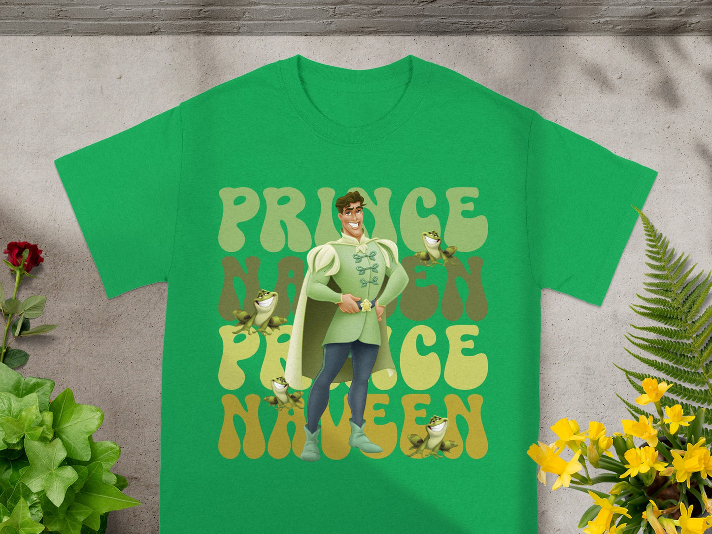 Green t-shirt with Prince Naveen and frogs graphic.