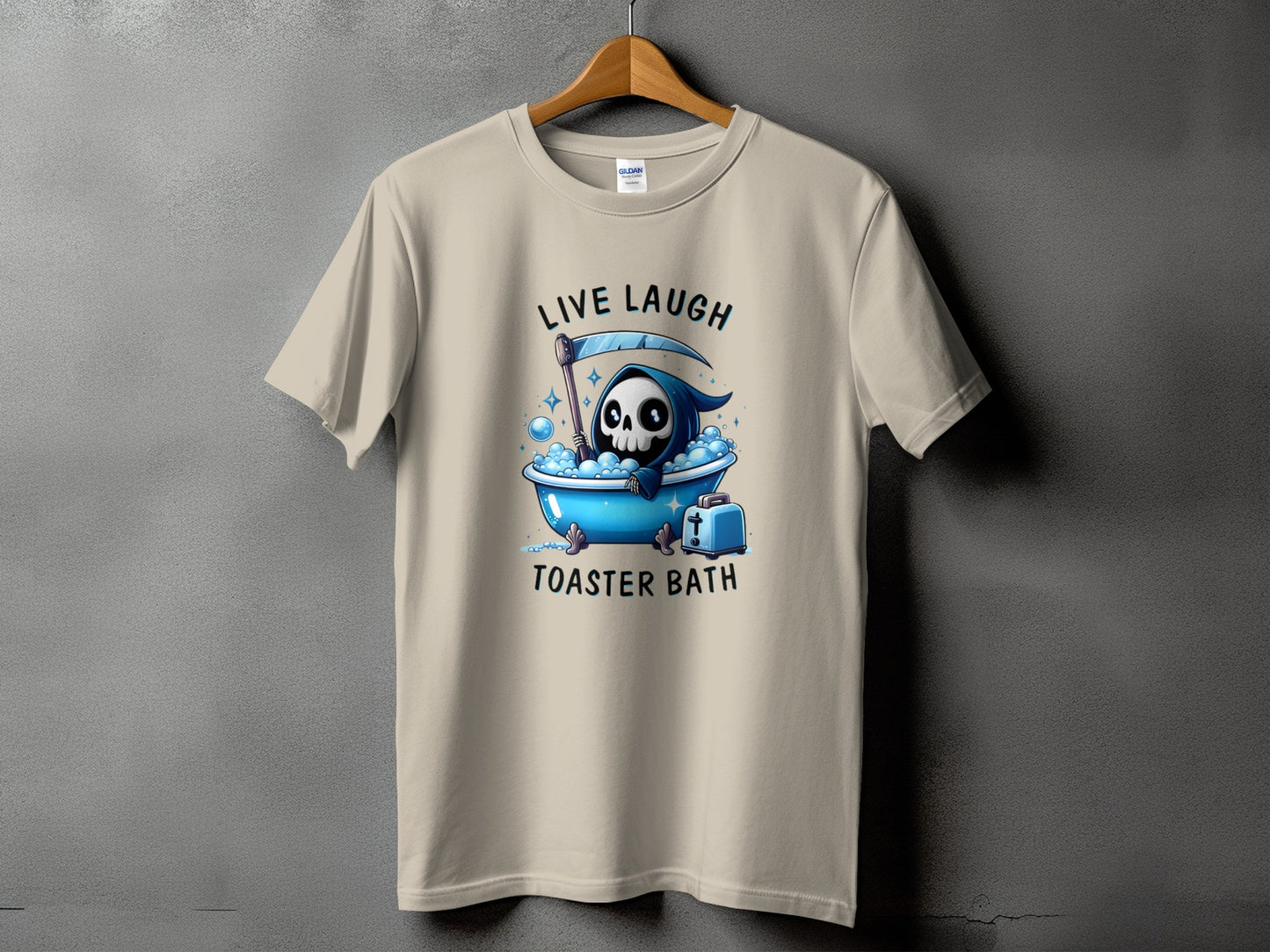 Tan t-shirt with Grim Reaper skeleton in bathtub graphic and text "LIVE LAUGH TOASTER BATH".