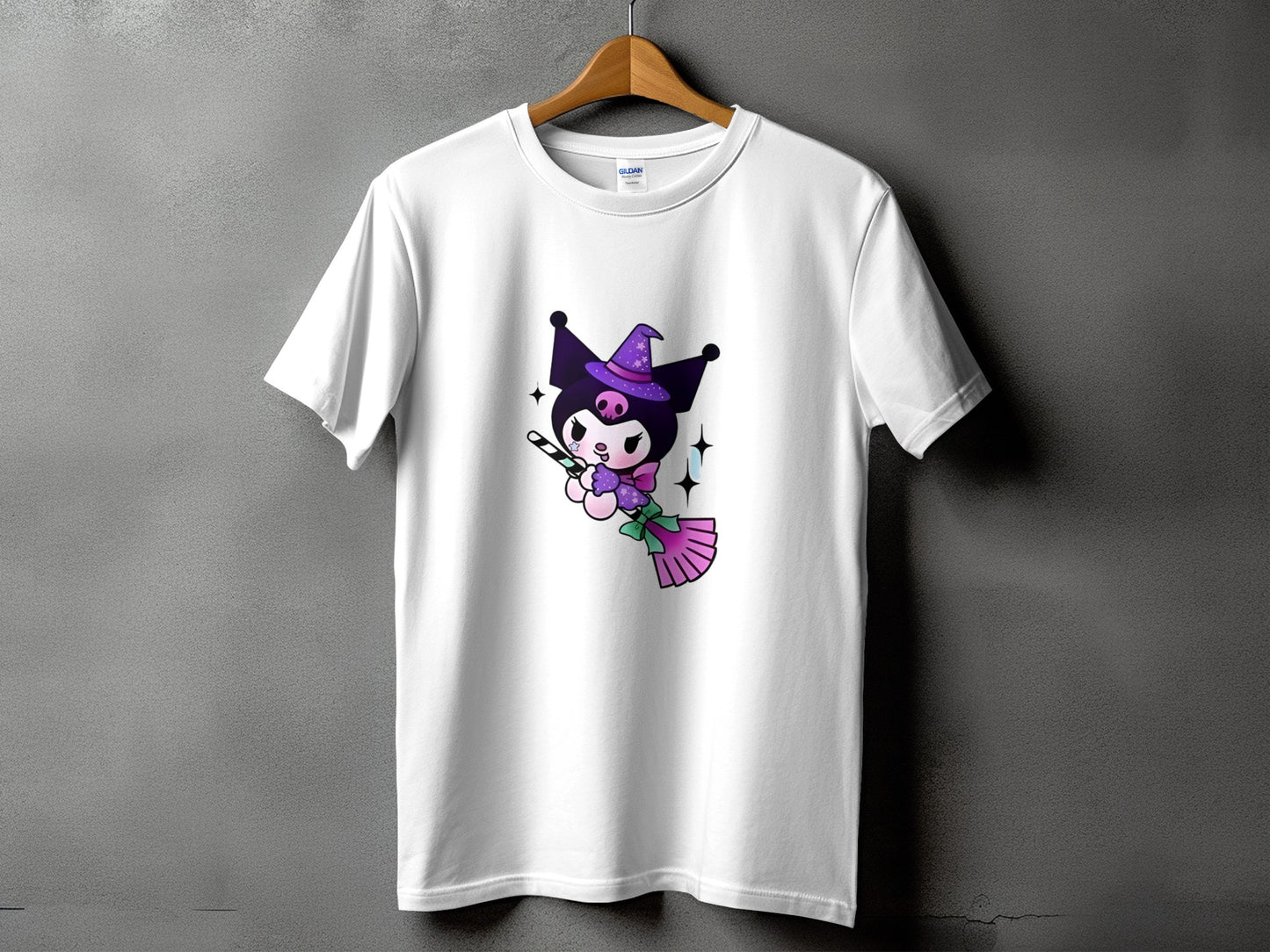 White t-shirt with a cartoon character wearing a witch hat and holding a candy cane.
