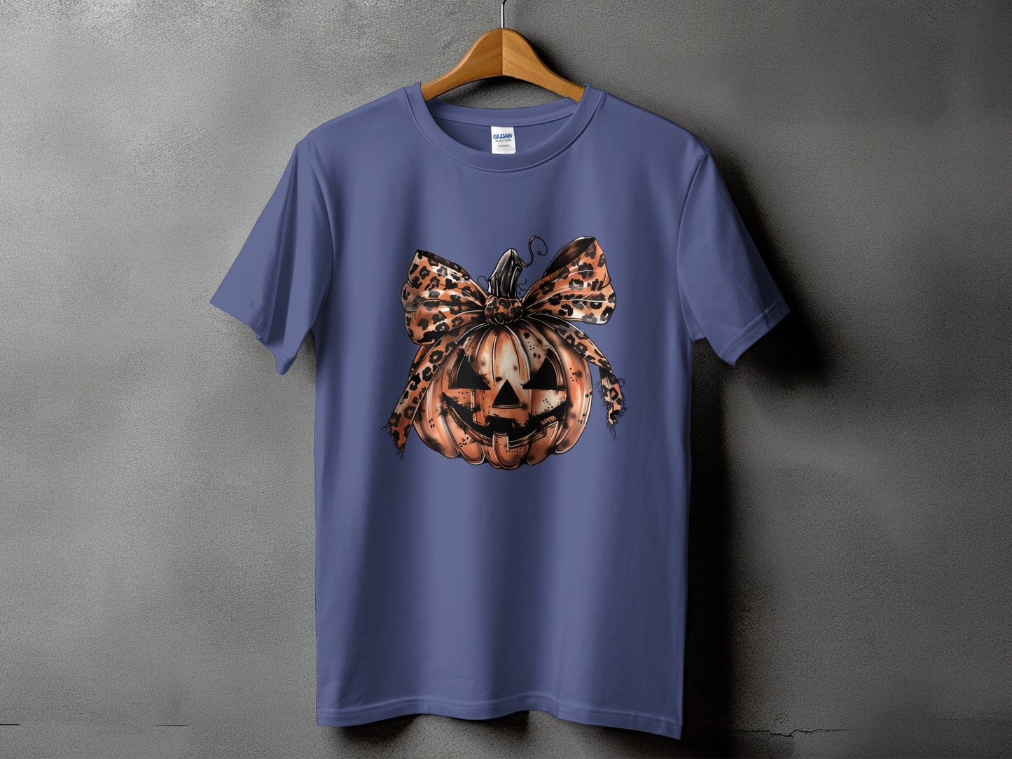 Purple t-shirt with a graphic of a Halloween pumpkin wearing a leopard print bow.