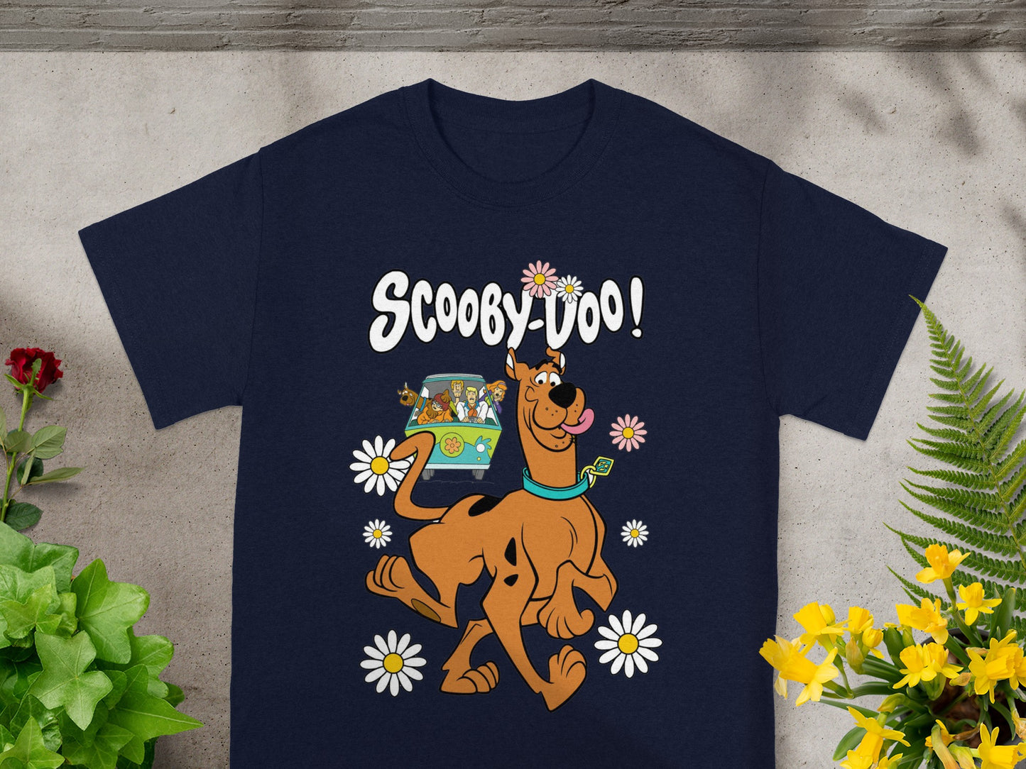 Scooby-Doo graphic on a navy blue t-shirt with Mystery Machine and flowers.