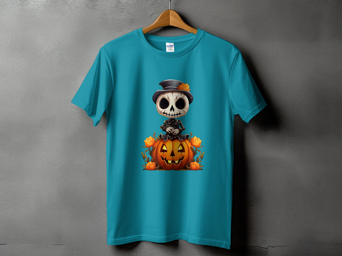 Teal t-shirt with cartoon skeleton sitting on a Halloween pumpkin with roses.