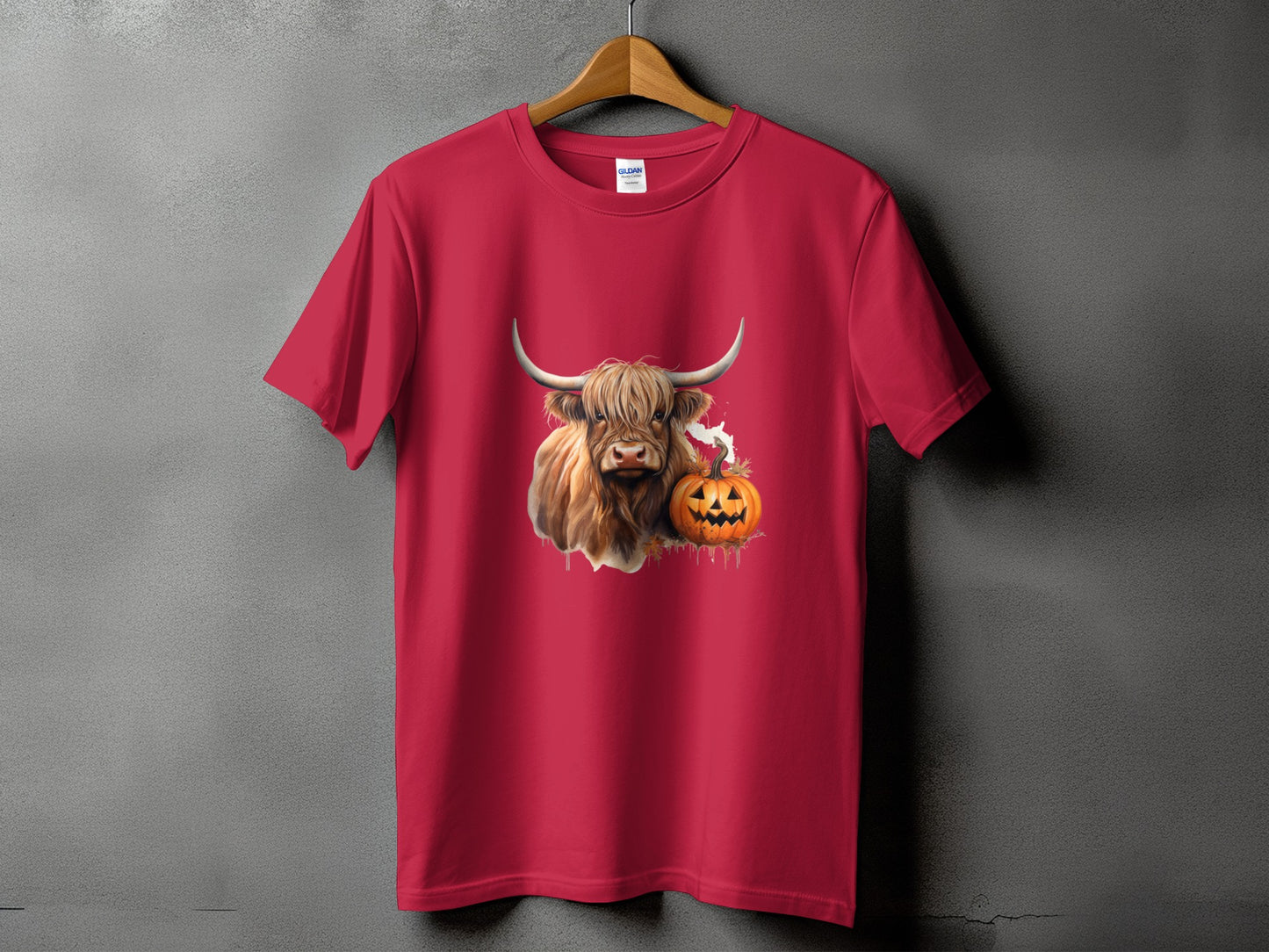 Red t-shirt with a Highland cow and jack-o'-lantern graphic.