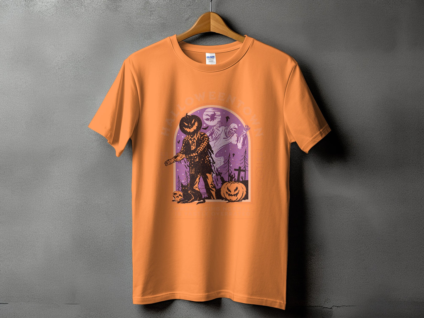 Orange t-shirt with Halloween Town graphic featuring scarecrow, ghost, and pumpkins.
