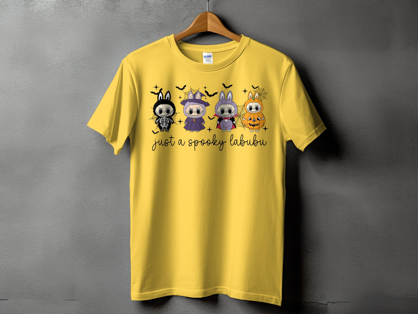 Yellow t-shirt with four Halloween-themed Labubu characters and "just a spooky labubu" text.