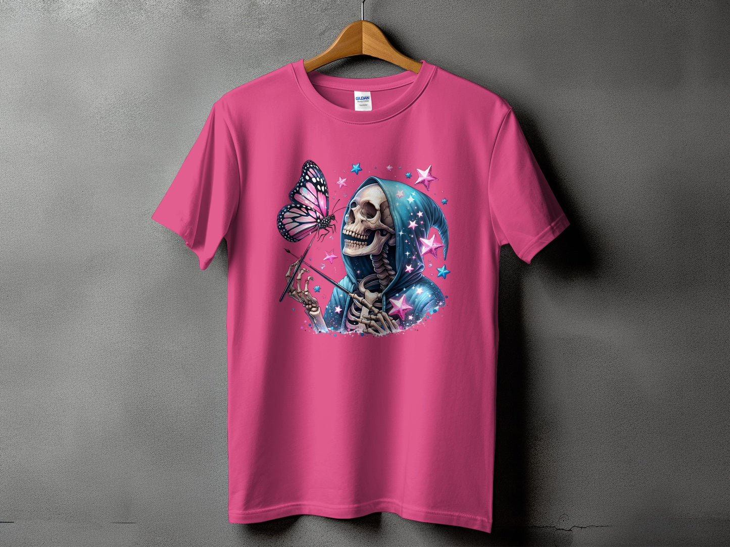 Pink t-shirt with a skeleton in a hooded robe holding a wand, with a butterfly.
