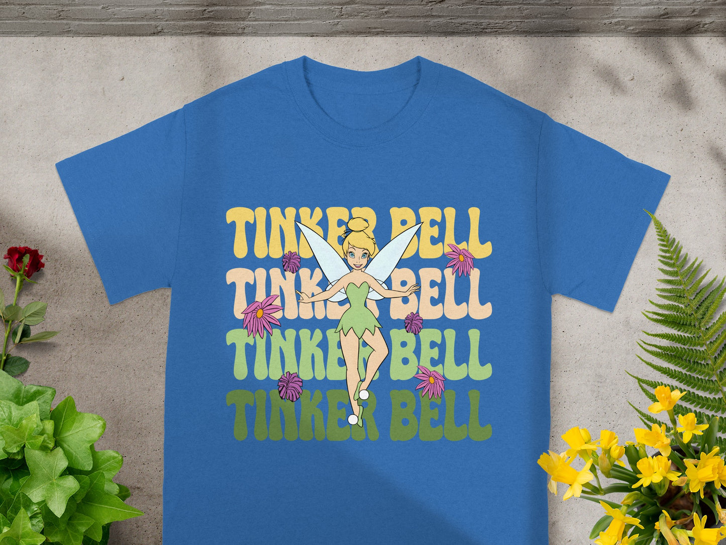 Blue t-shirt with Tinker Bell graphic and stacked "Tinker Bell" text.
